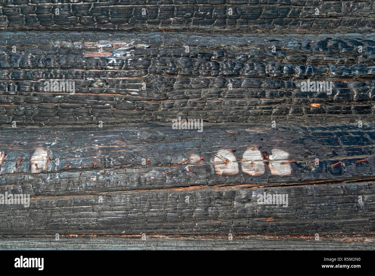 Texture of charred logs. Burned wooden charred log house texture. closeup Stock Photo