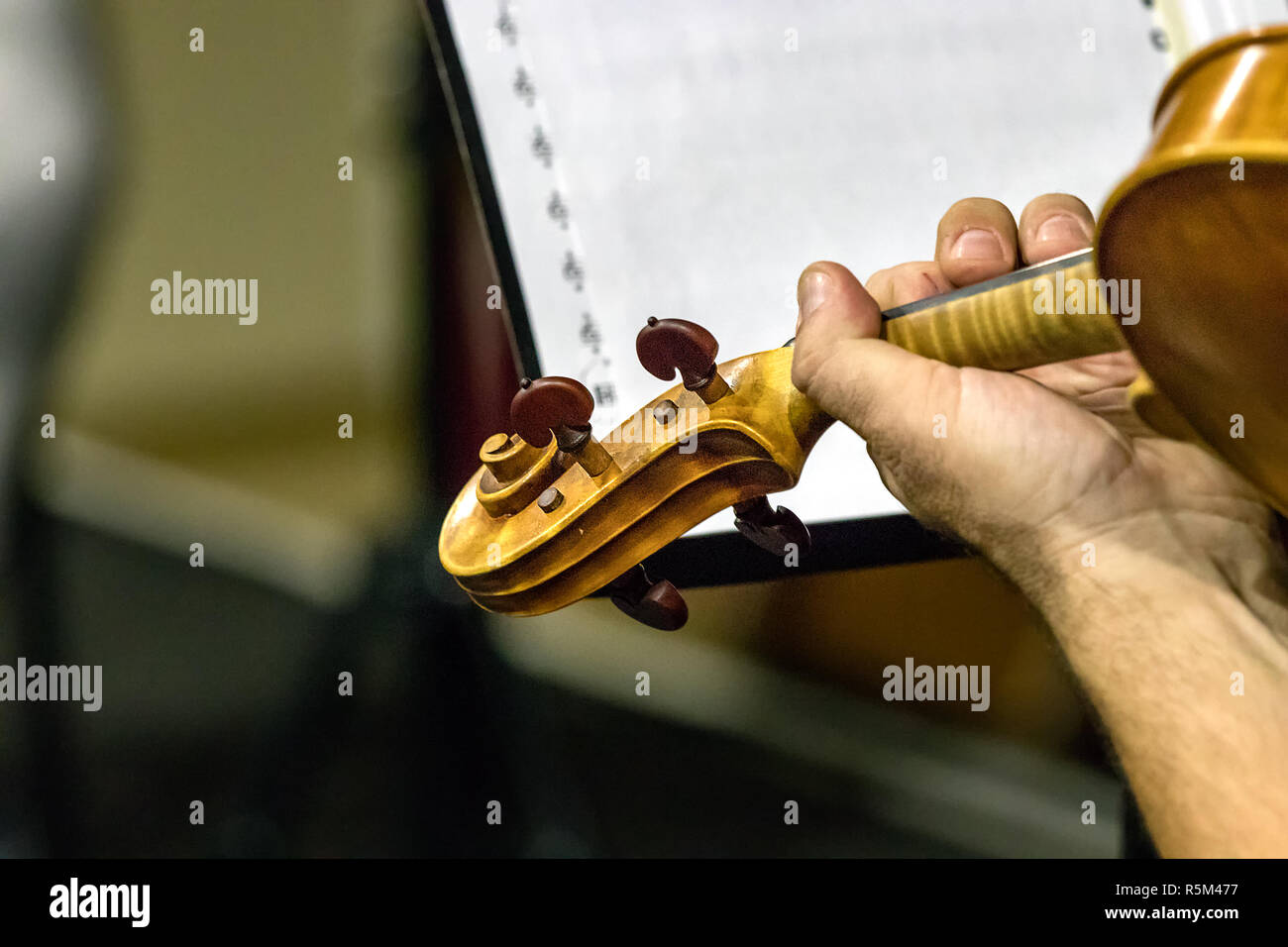 Close up of the Scroll - peg box of a violin during a live performance. Stock Photo