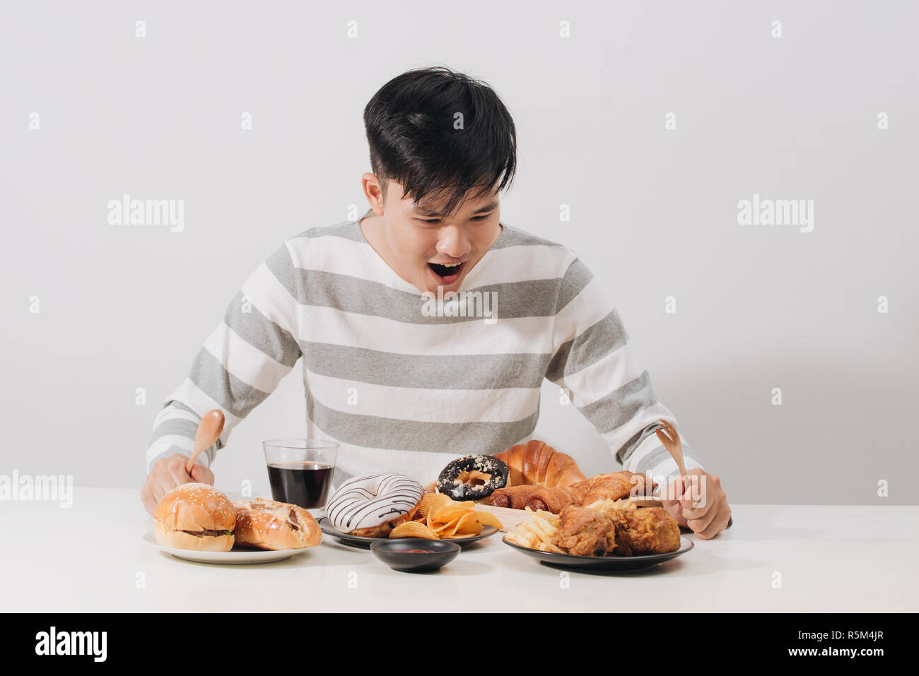 Young man at home on a unhealthy diet Stock Photo