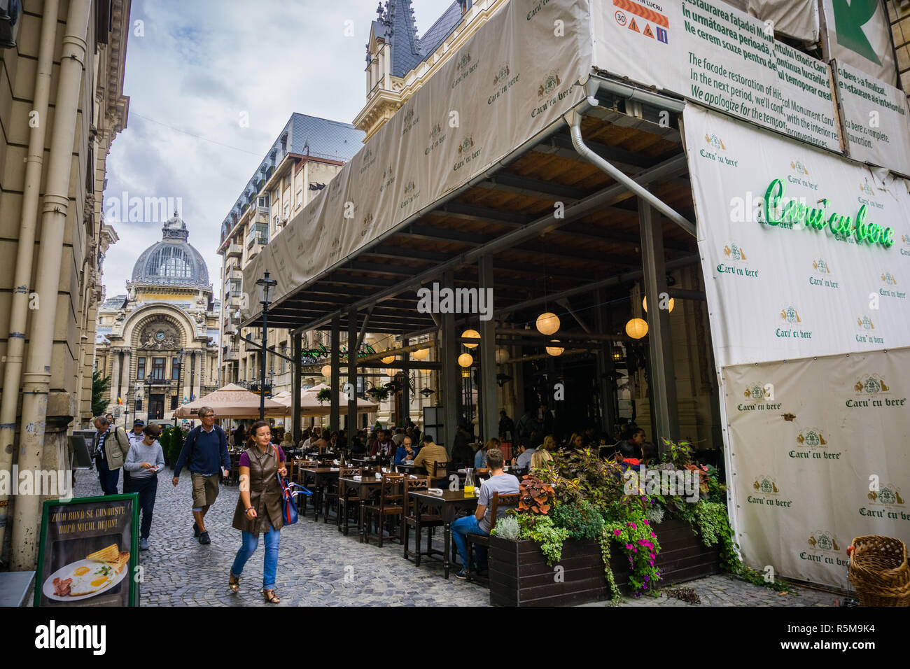 September 22, 2017 Bucharest/Romania - Outdoor seating at Caru' cu Bere Romanian traditional restaurant in the Old town downtown area; CEC Bank histor Stock Photo
