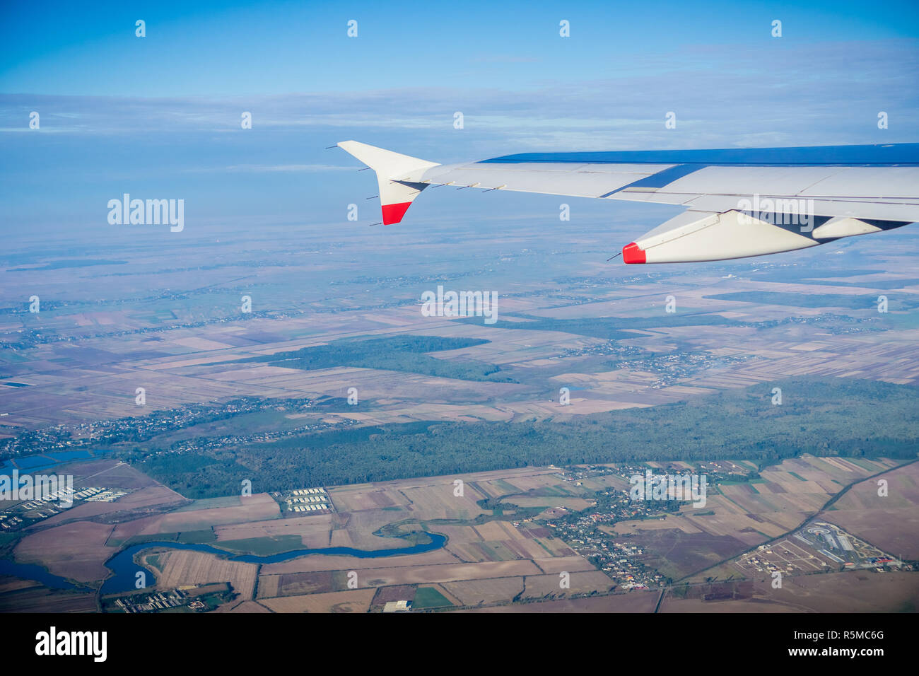 Window view of flying over the Romanian countryside after taking off from Bucharest, Romania Stock Photo