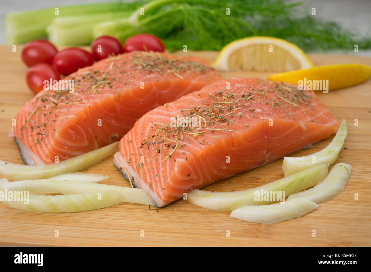 Salmon and Vegetables on a Cutting Board Stock Photo