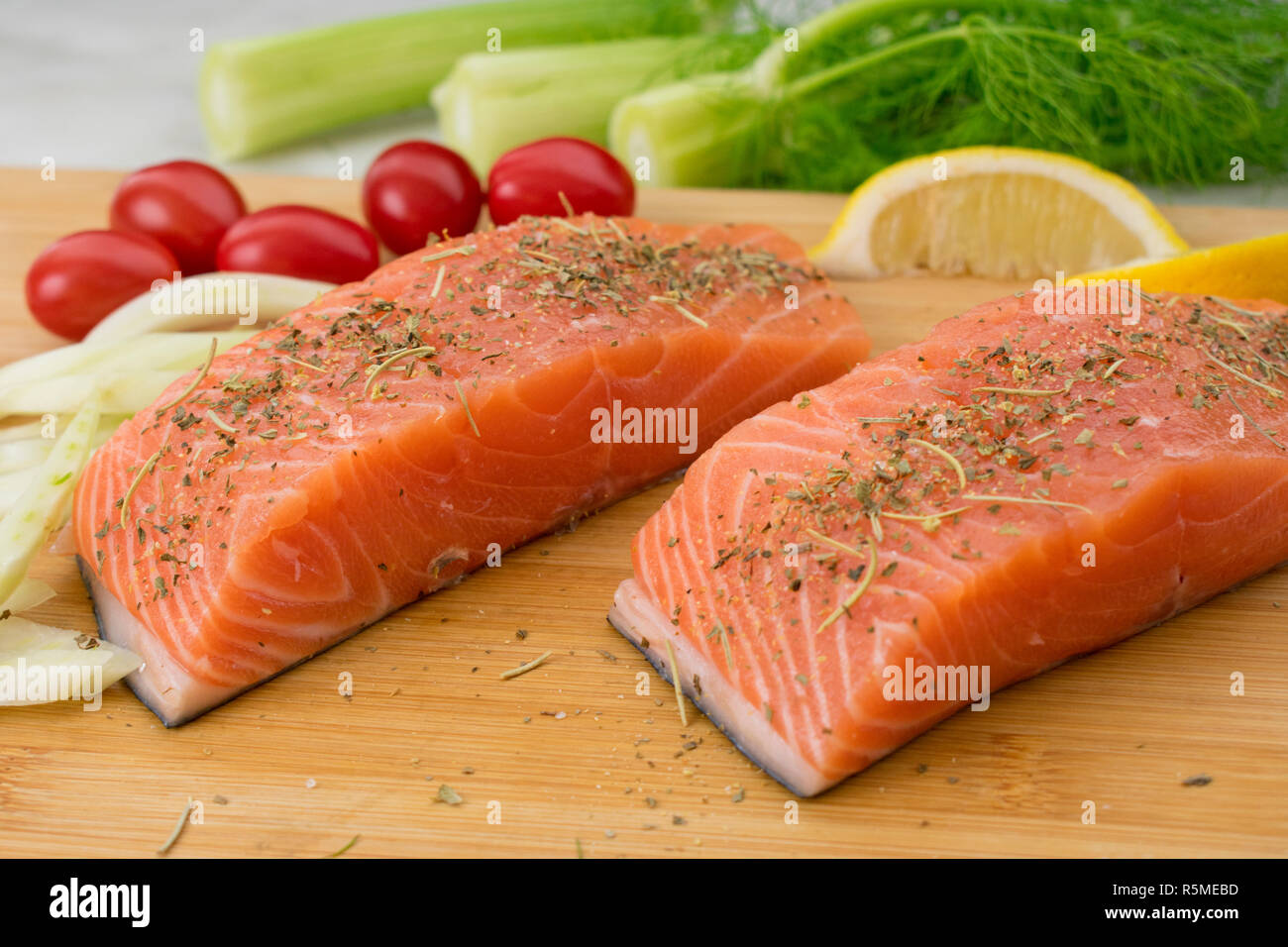 Salmon and Vegetables on a Cutting Board Stock Photo