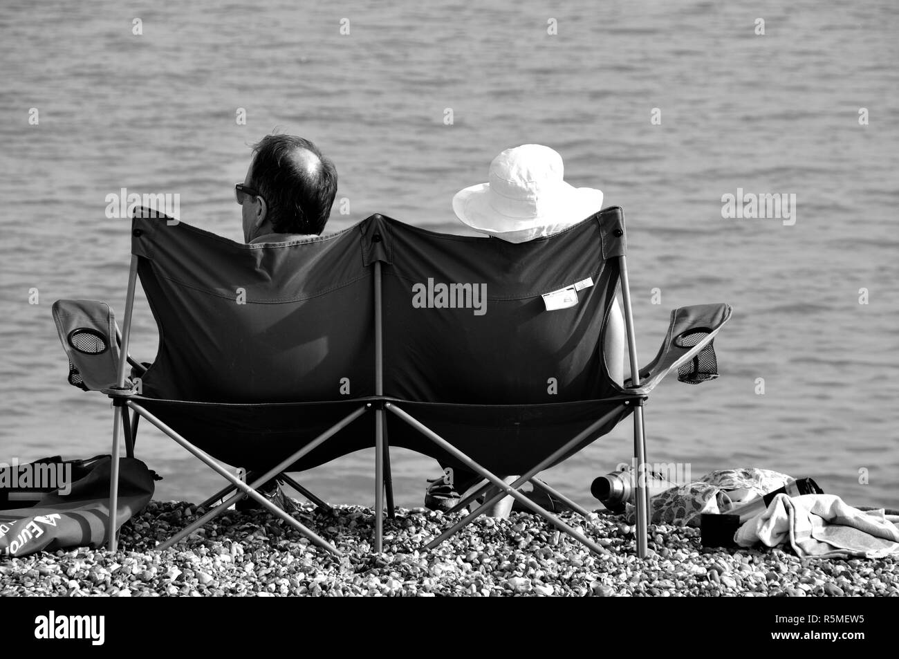 Relaxing On The Beach Pevensey Bay East SussexCouple Stock Photo