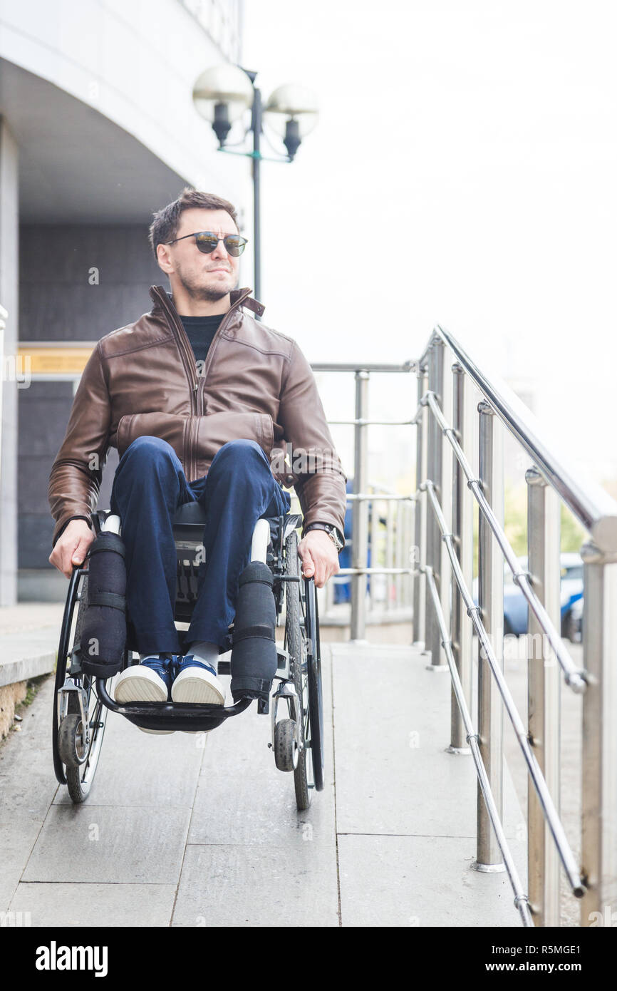 Man in a wheelchair use a wheelchair ramp Stock Photo - Alamy
