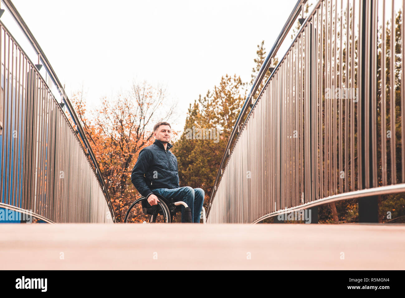 Man in a wheelchair use a wheelchair ramp Stock Photo - Alamy