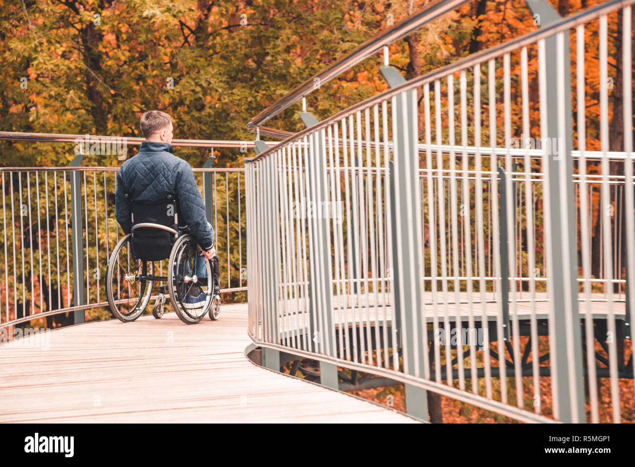 Man in a wheelchair use a wheelchair ramp Stock Photo - Alamy