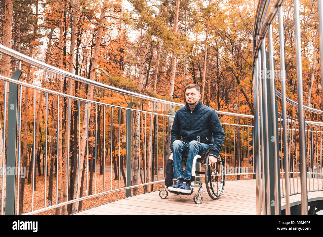 Man in a wheelchair use a wheelchair ramp Stock Photo - Alamy