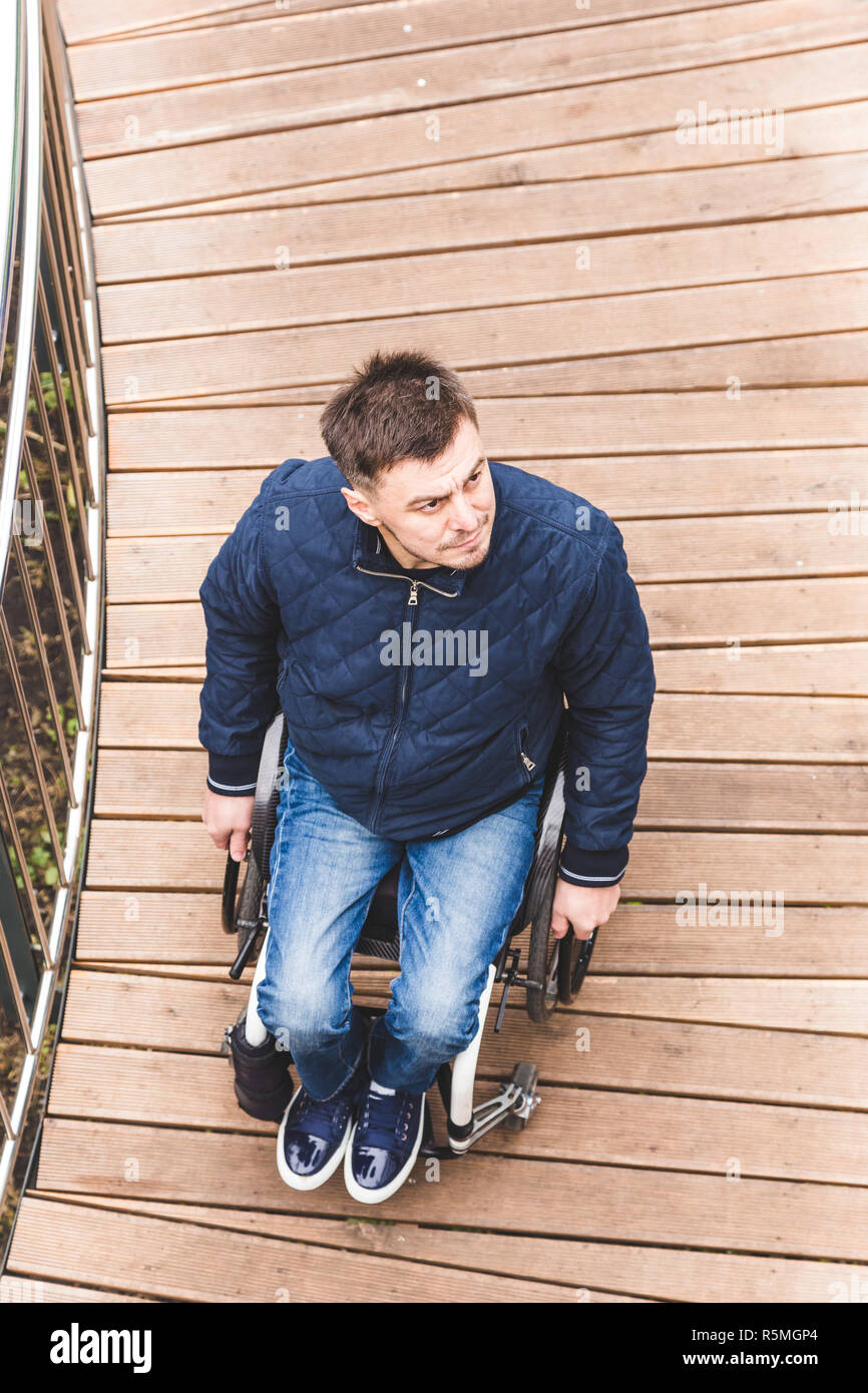 Man in a wheelchair use a wheelchair ramp Stock Photo - Alamy