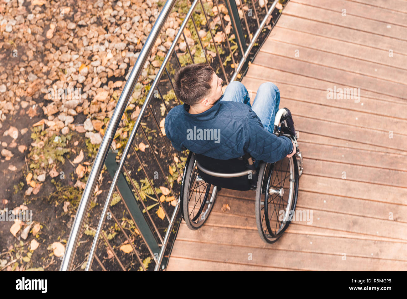 Man in a wheelchair use a wheelchair ramp Stock Photo - Alamy