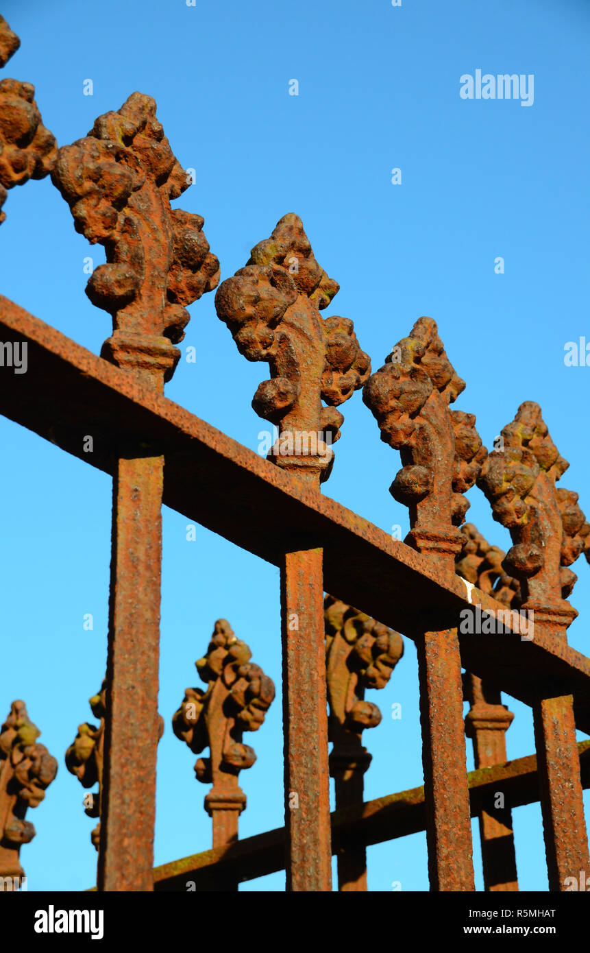 top section of old rusty ornate wrought iron  railings Stock Photo