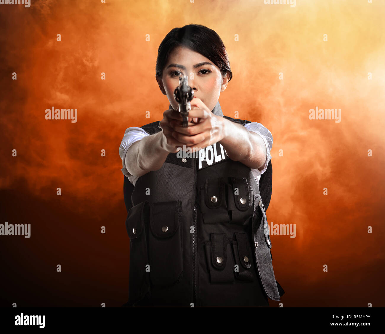 Woman holding smoking gun hires stock photography and images Alamy