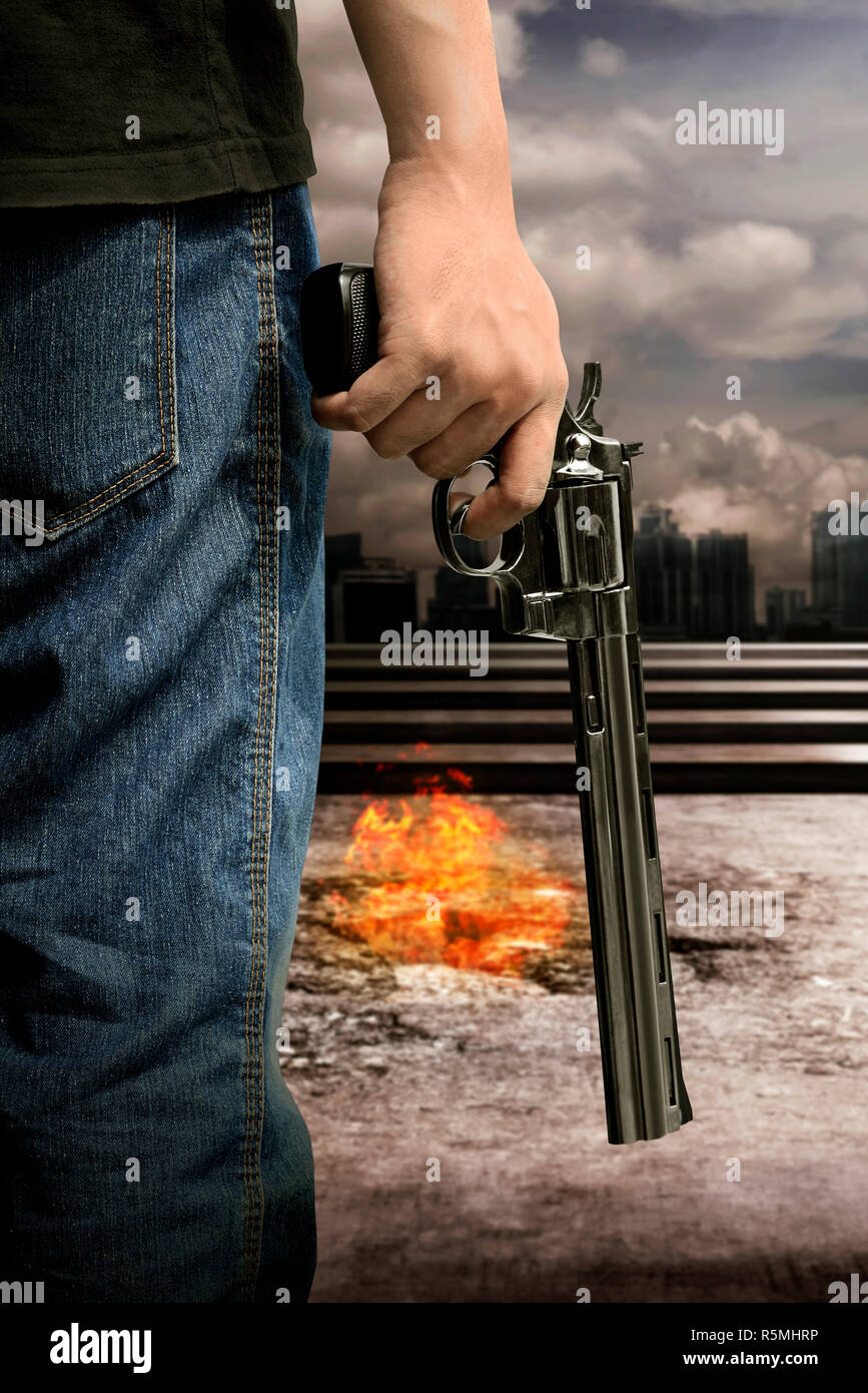 Man hand holding gun Stock Photo Alamy