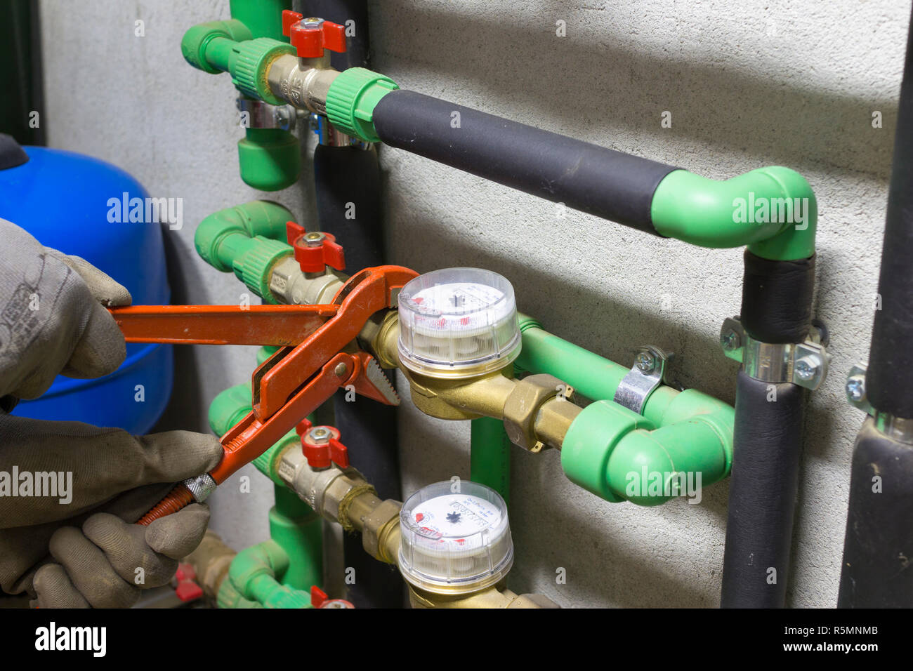 plumber at work installing a water meter Stock Photo Alamy