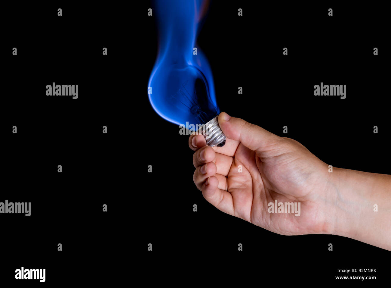 Human hand holding lightbulb burning with blue flame Stock Photo Alamy