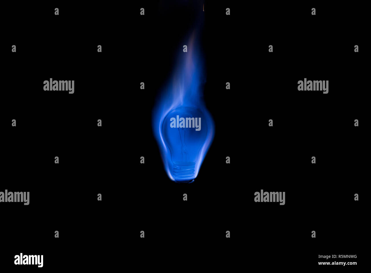 Tungsten light bulb burning with a beautiful blue flame Stock Photo Alamy
