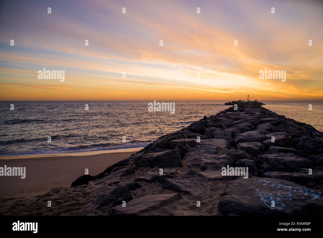 Rocky Jetty and Ocean at Sunrise Stock Photo - Alamy