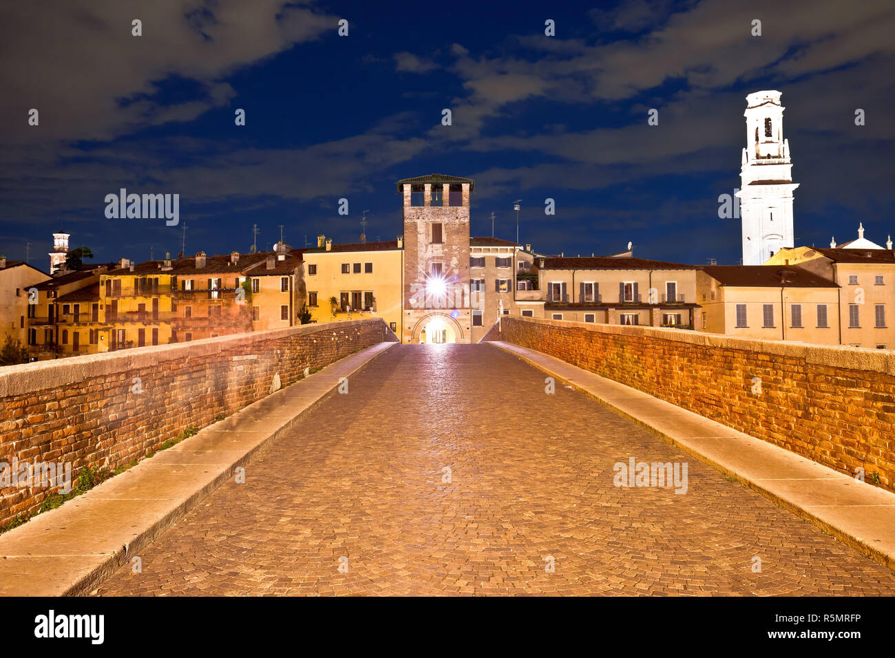 Ponte Pietra bridge and Verona waterfront architecture evening view