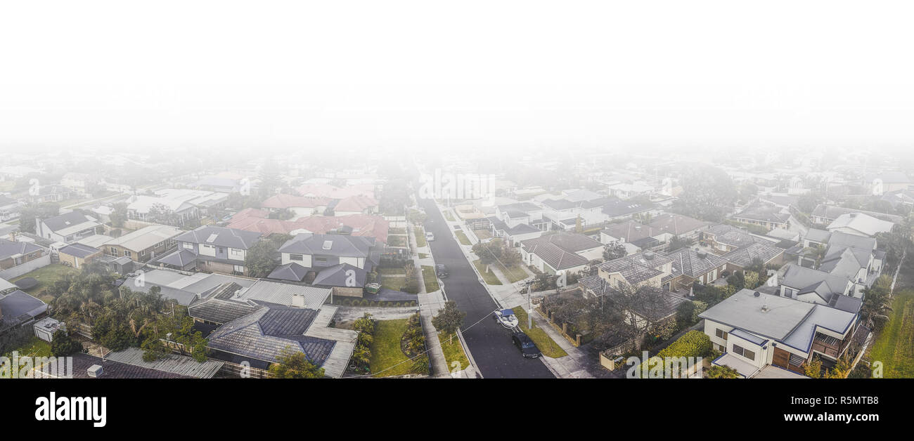 Aerial panorama of real estate in Australia under low clouds and haze Stock Photo