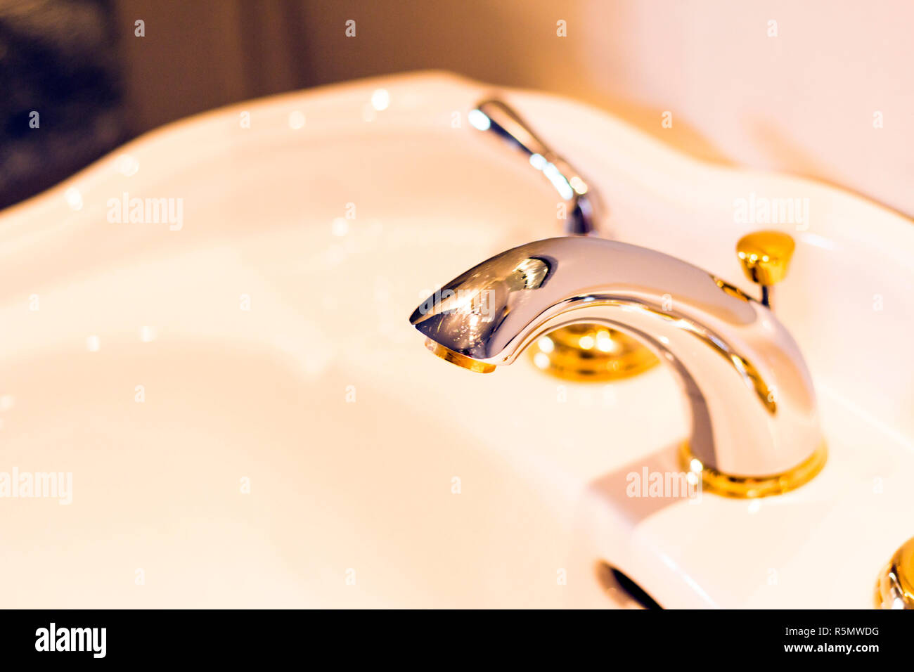 Silver and gold faucet Stock Photo Alamy