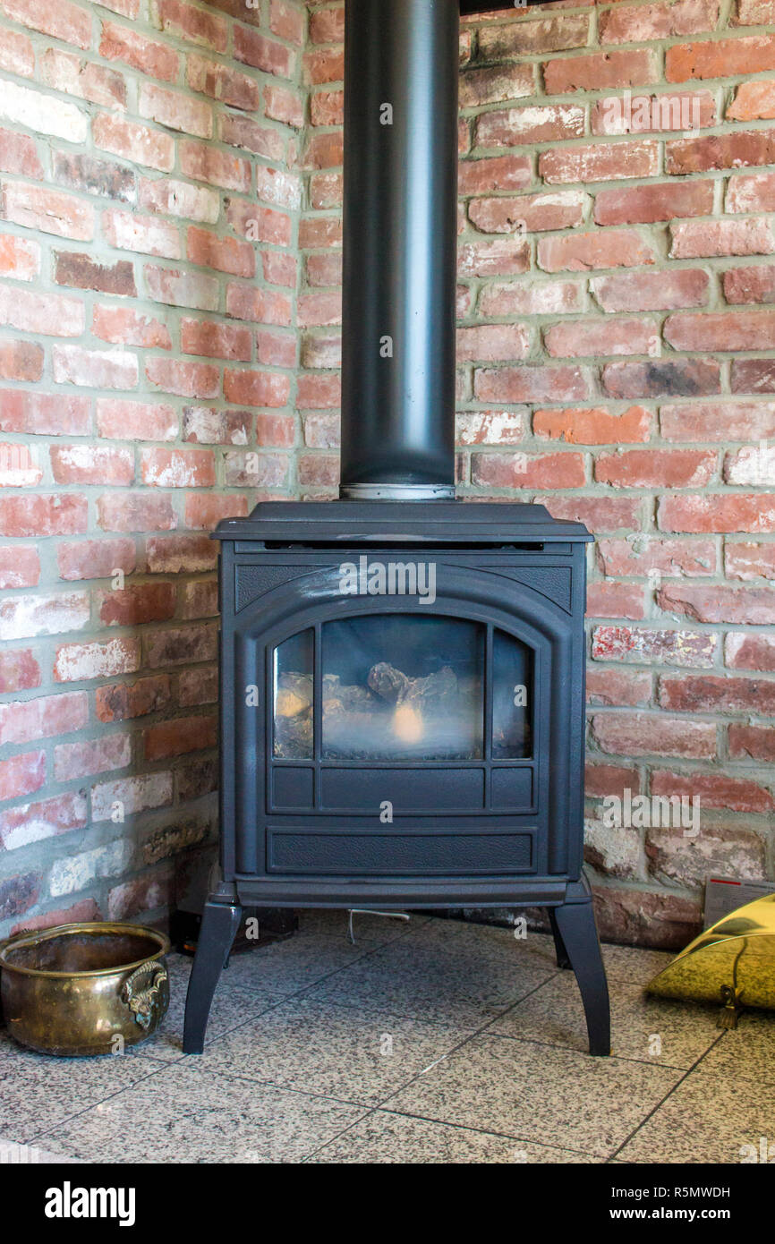 Wood burning stove and brick wall Stock Photo Alamy