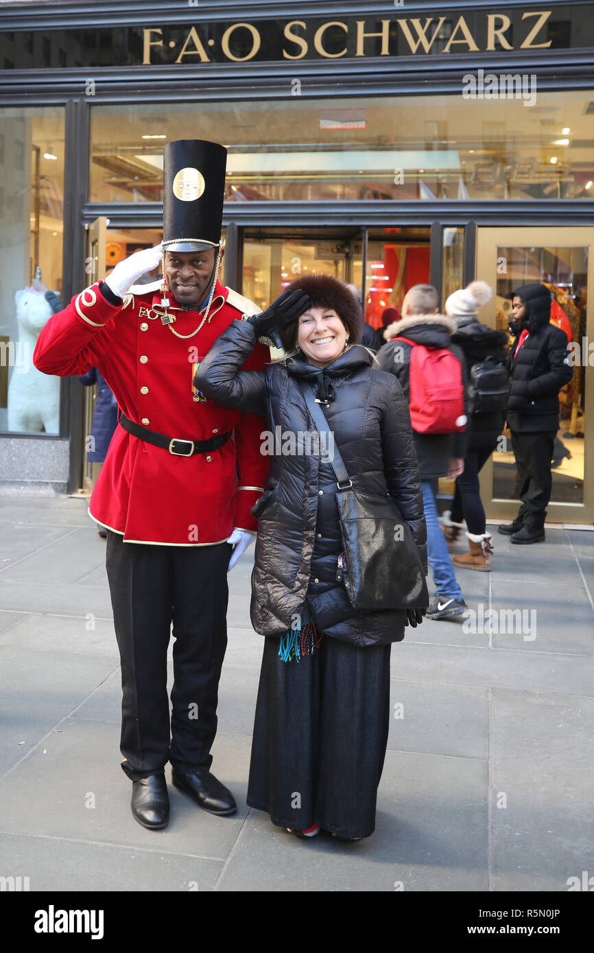 A doorman dressed as a toy soldier stands outside newly reopened the FAO Schwarz flagship store at Rockefeller Plaza in Midtown Manhattan Stock Photo Alamy