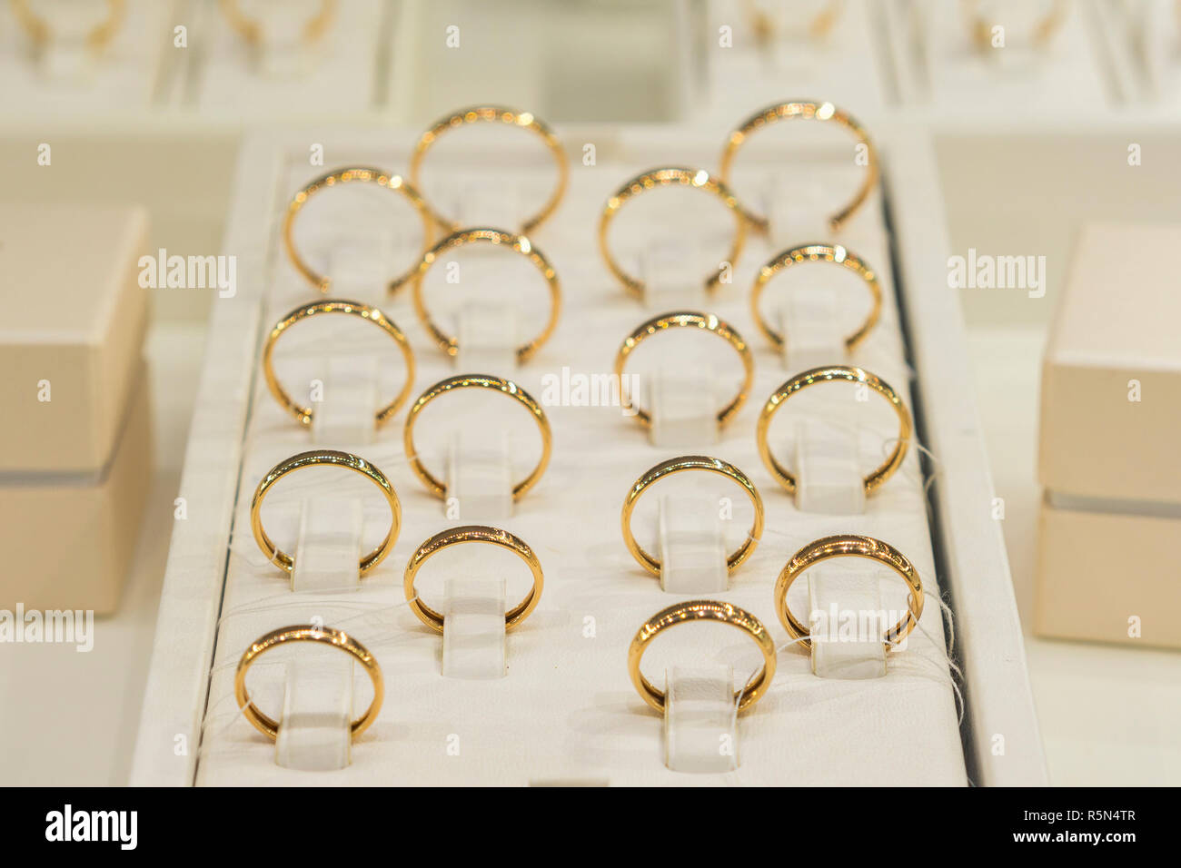 golden rings store. Wedding gold rings on the showcase. Wedding ring