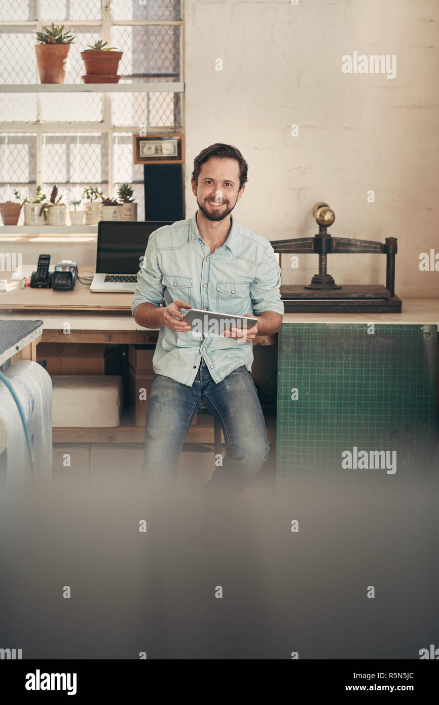 Designer businessman in his studio using a digital tablet Stock Photo