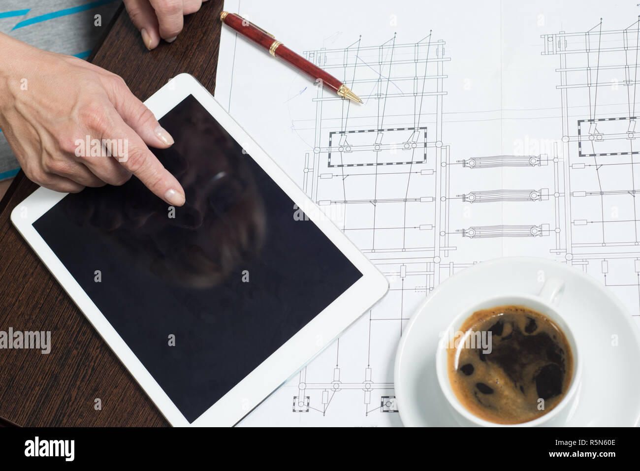 Business woman uses a tablet and graphics for the planning and analysis of market data Stock Photo