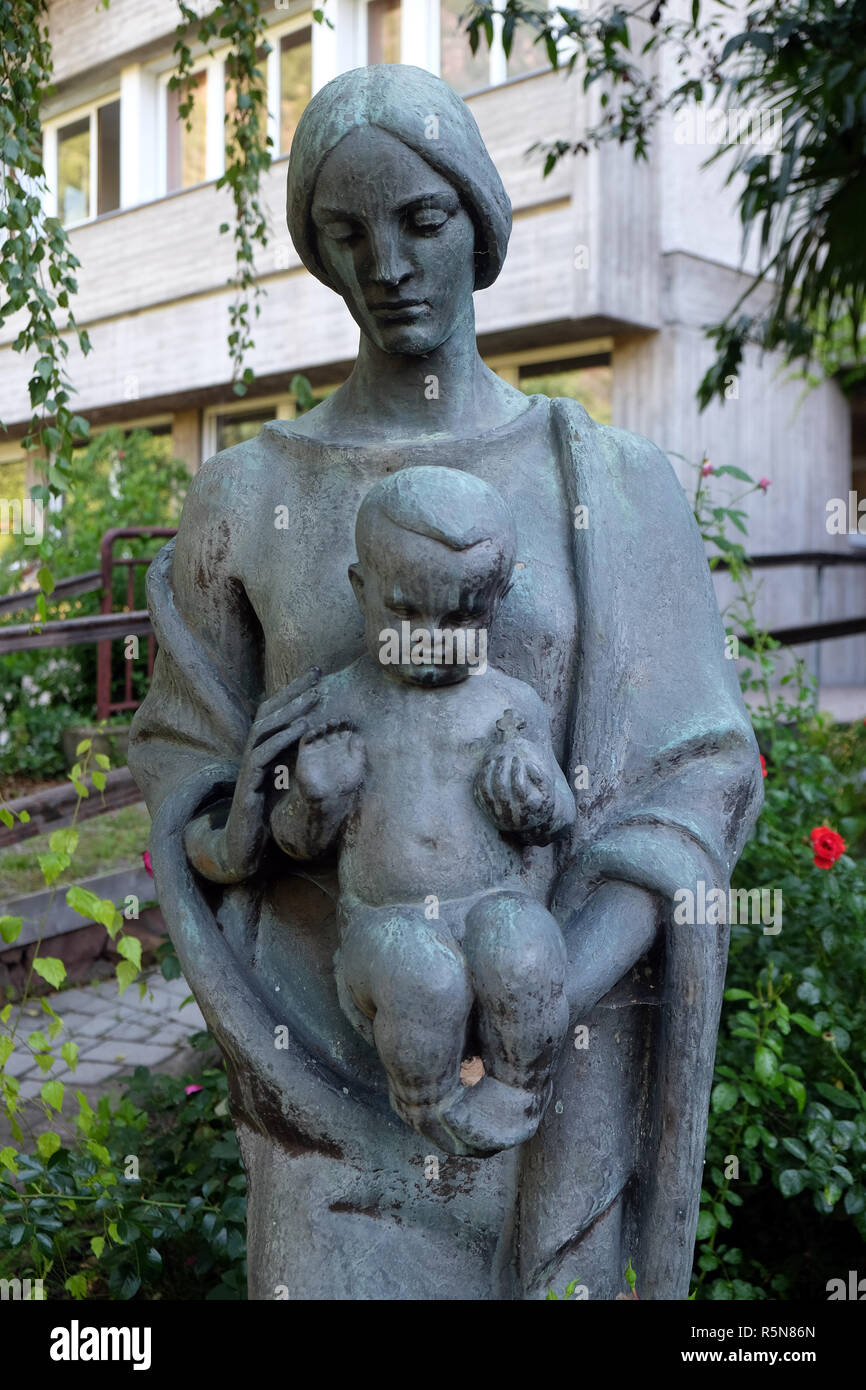 Virgin Mary with baby Jesus statue in the garden of the Blind Center Saint Raphael in Bolzano, Italy Stock Photo