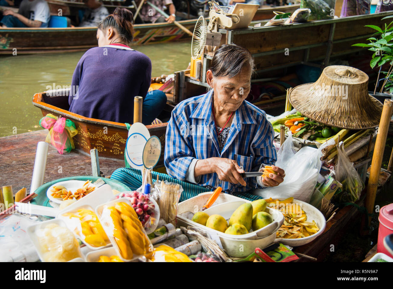 Damnoen Saduak Floating Market, 60 miles outside of Bangkok, is Thailand's most famous floating market, warmly welcoming and unique experience. Stock Photo