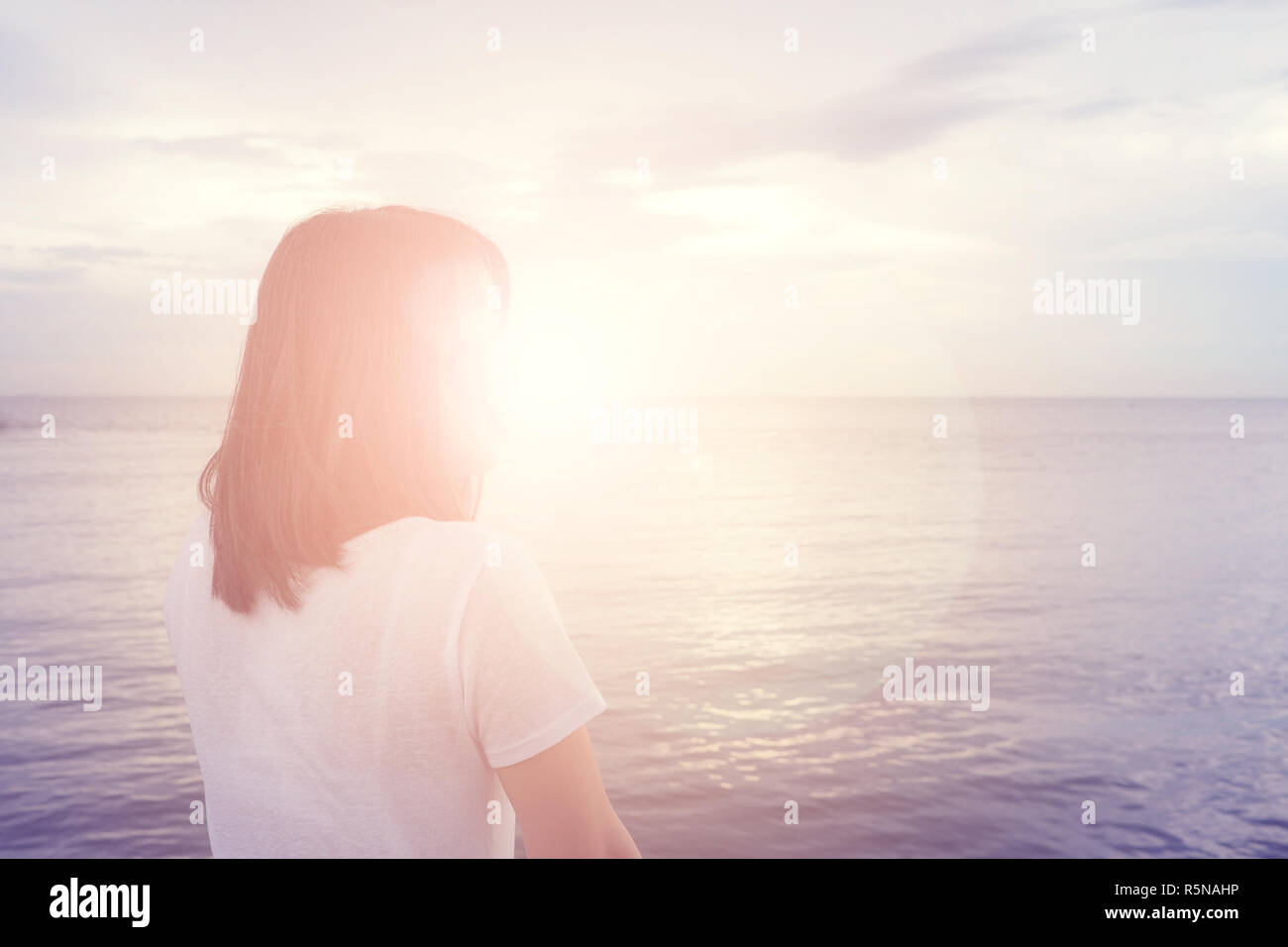 Woman watching sunset balcony hi-res stock photography and images - Alamy