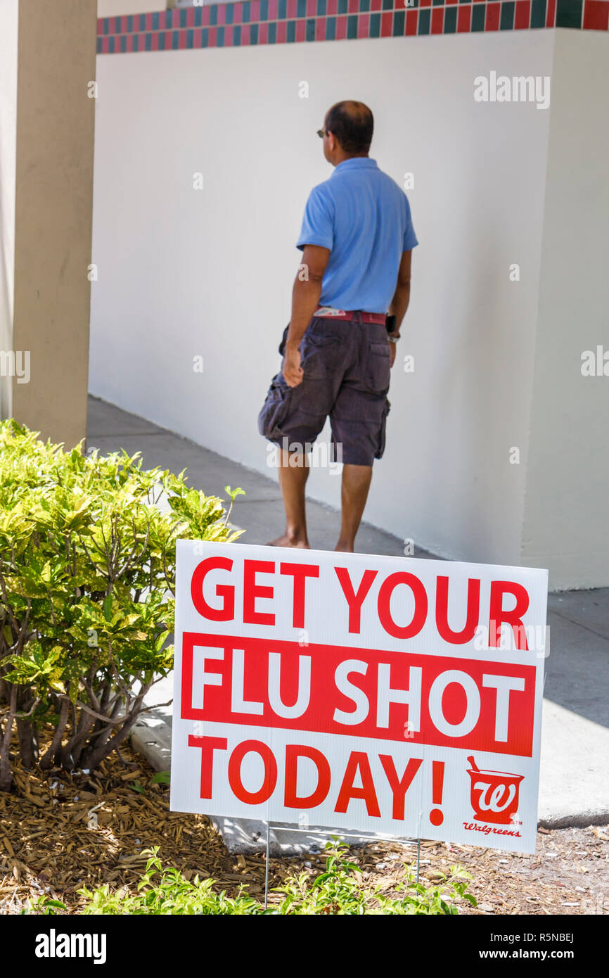 Miami Beach Florida,Walgreens Pharmacy,chain drug store,sign,flu shot,influenza,vaccine,prevention,injection,health,man men male adult adults,walking, Stock Photo