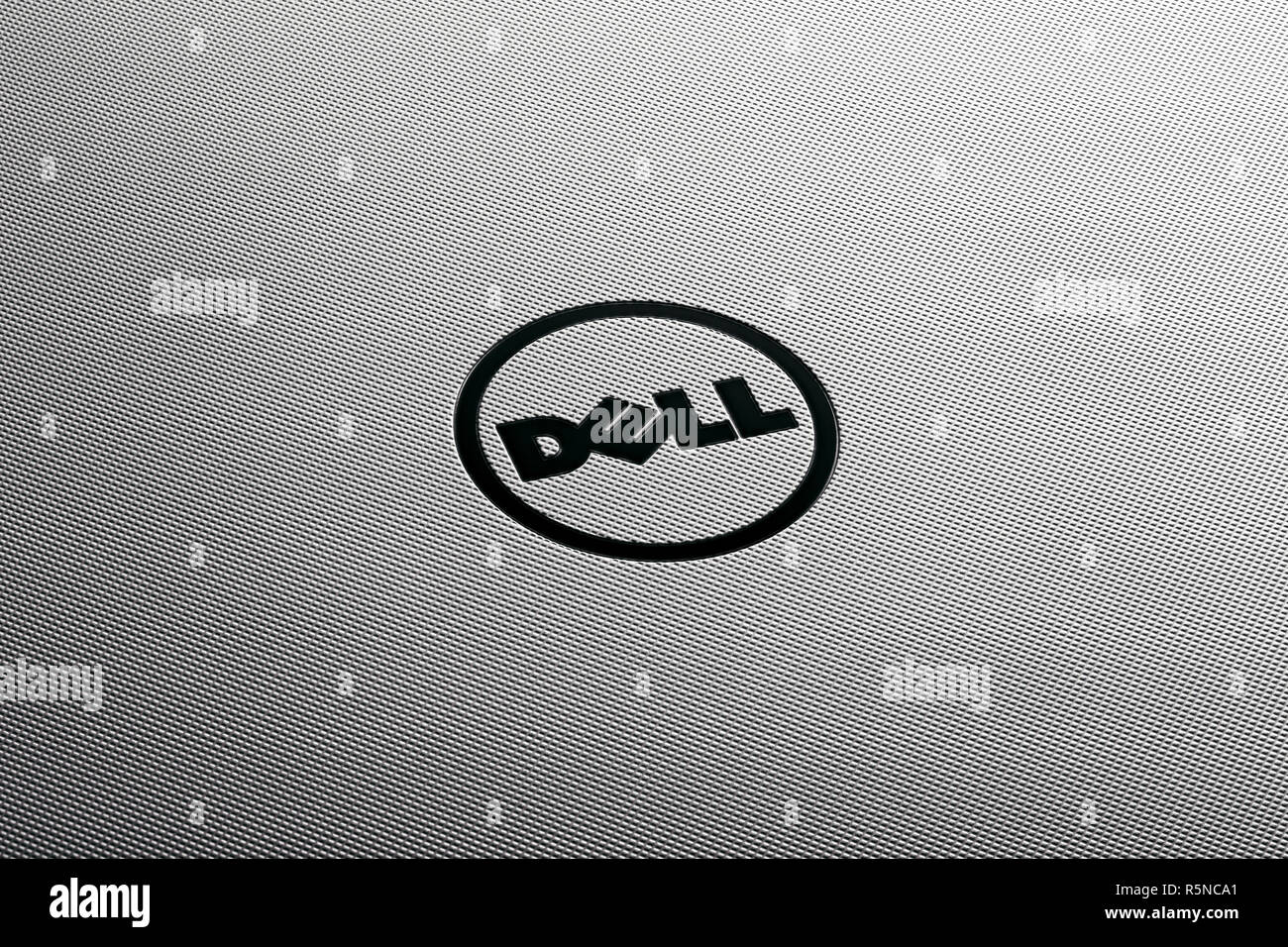 Close up Dell logo on the textured gray metal surface of a laptop cover. Stock Photo