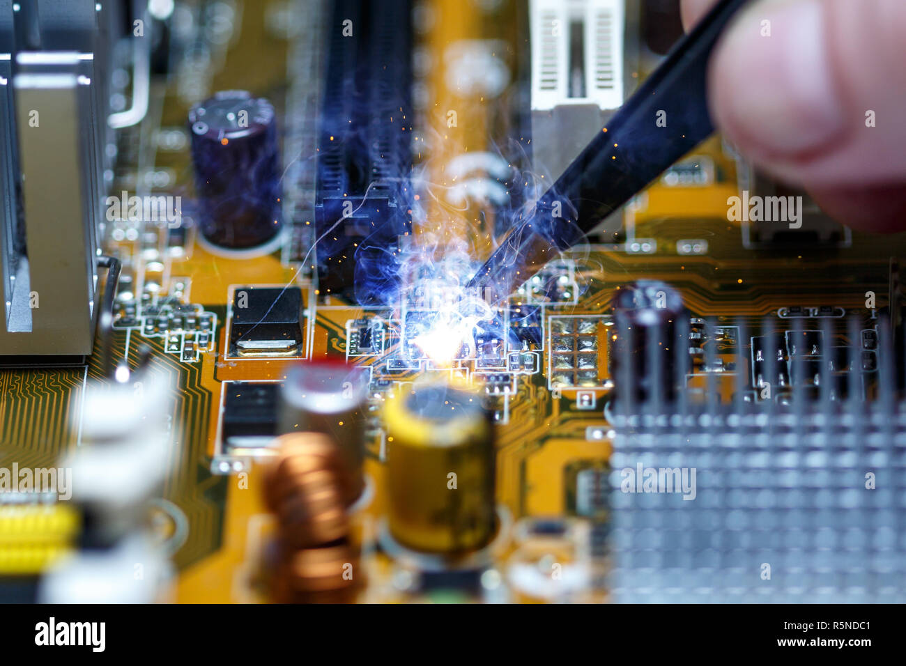 Short circuit on the motherboard during repair Stock Photo