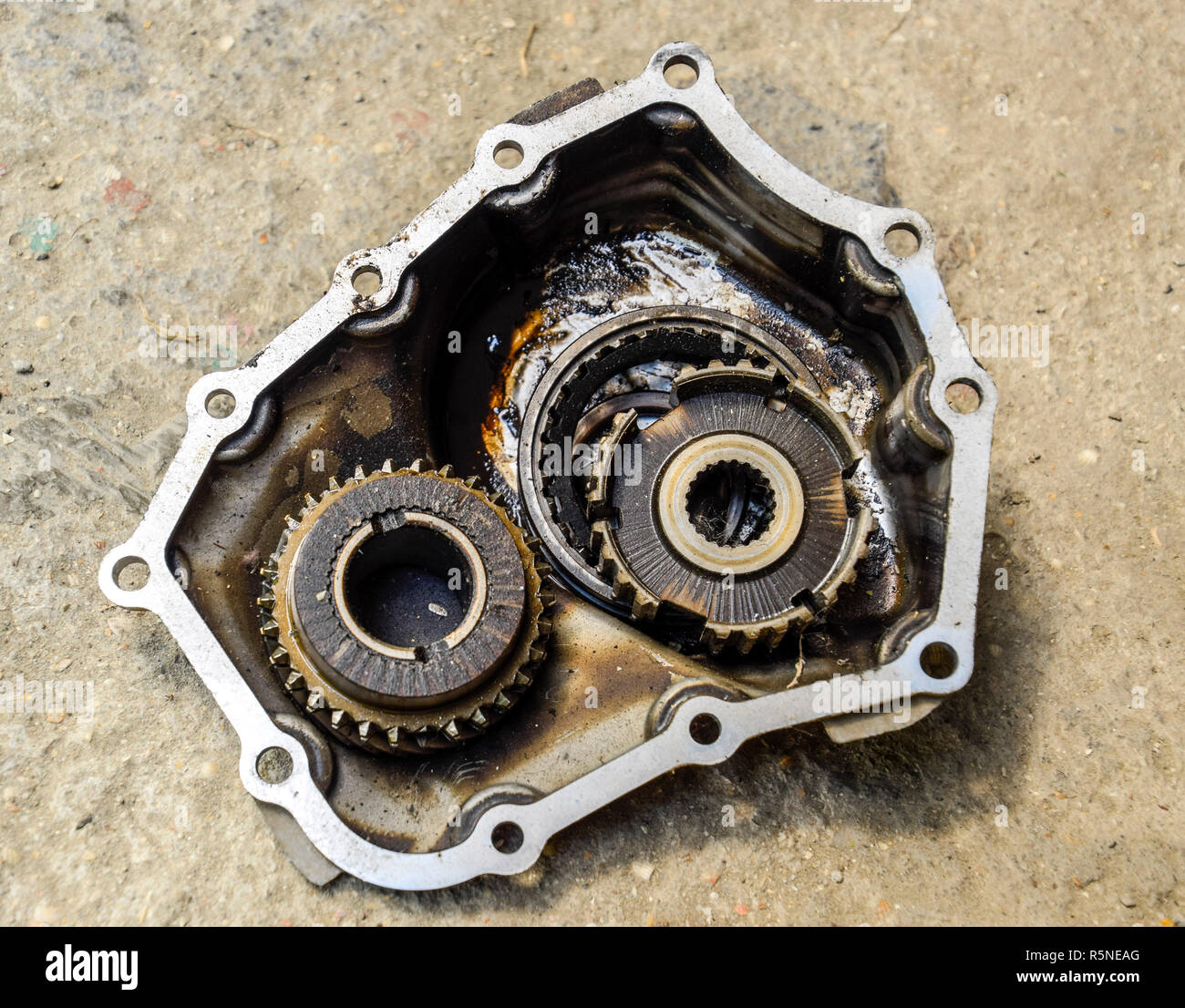 Dismantled box car transmissions. Gear with bearings and gearbox housing. The gears on the shaft of a mechanical transmission. Stock Photo