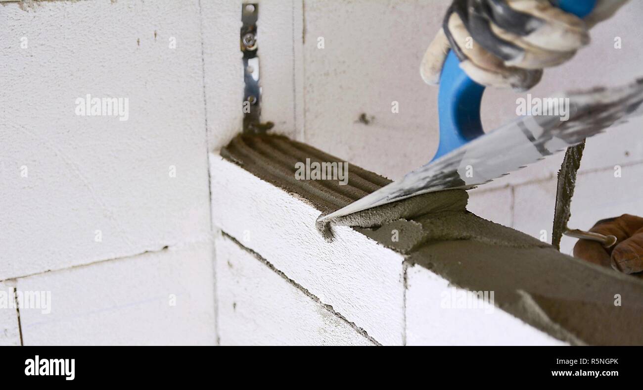 Levelling a mortar with a trowel Stock Photo