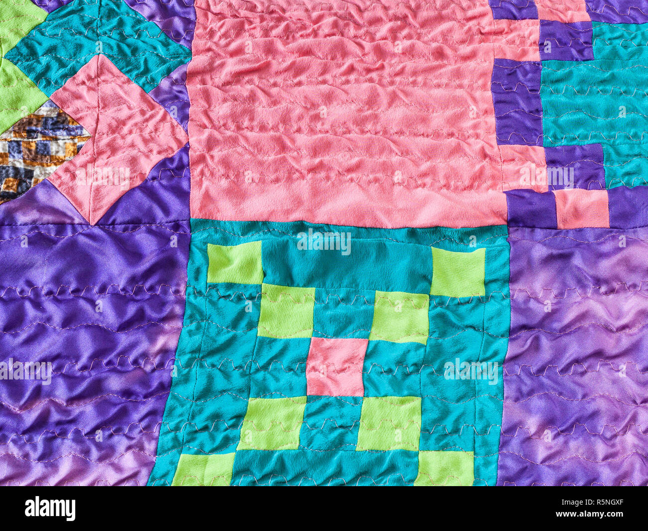 square pieces of fabrics in stitched patchwork Stock Photo