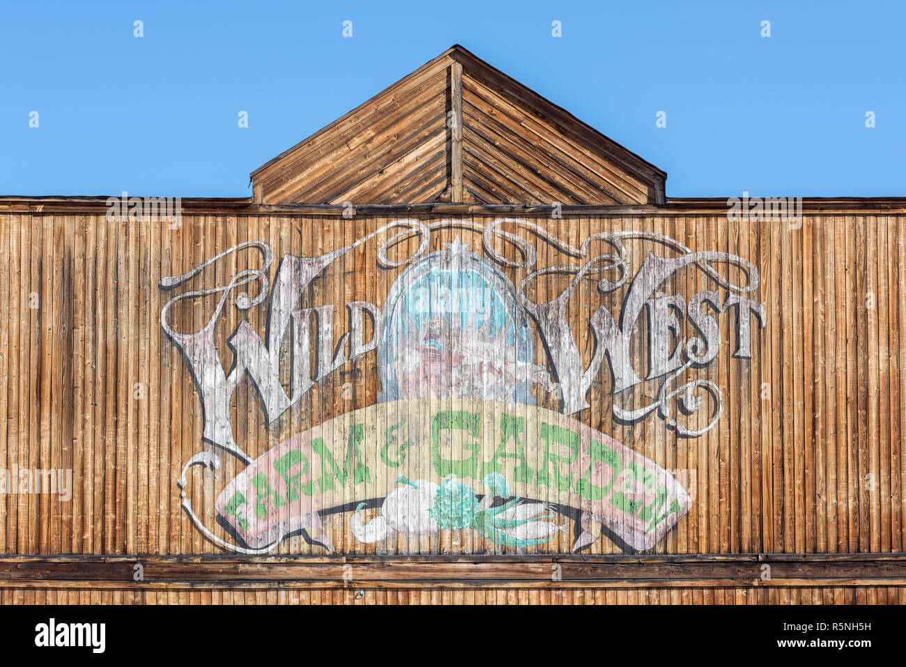 Sign on the facade of the Wild West Farm & Garden store in Republic, Washington. Stock Photo