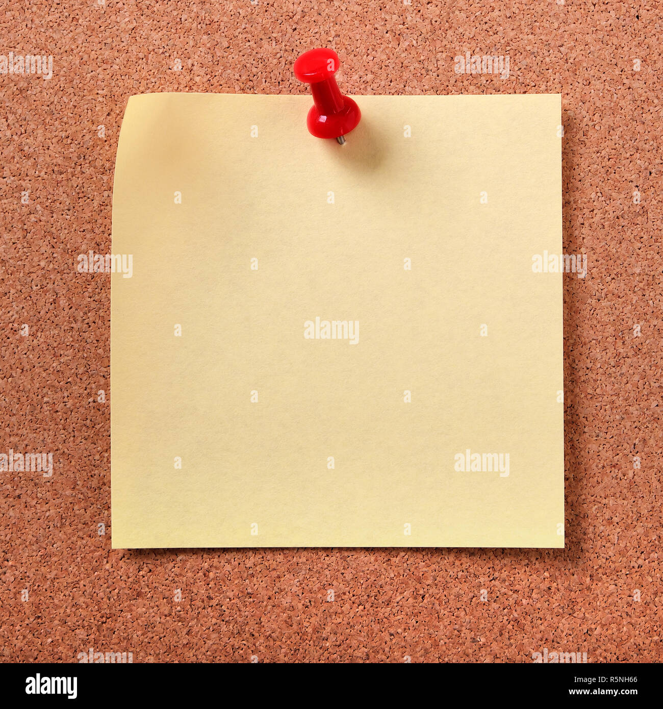 Yellow sticky post note pinned cork board Stock Photo - Alamy