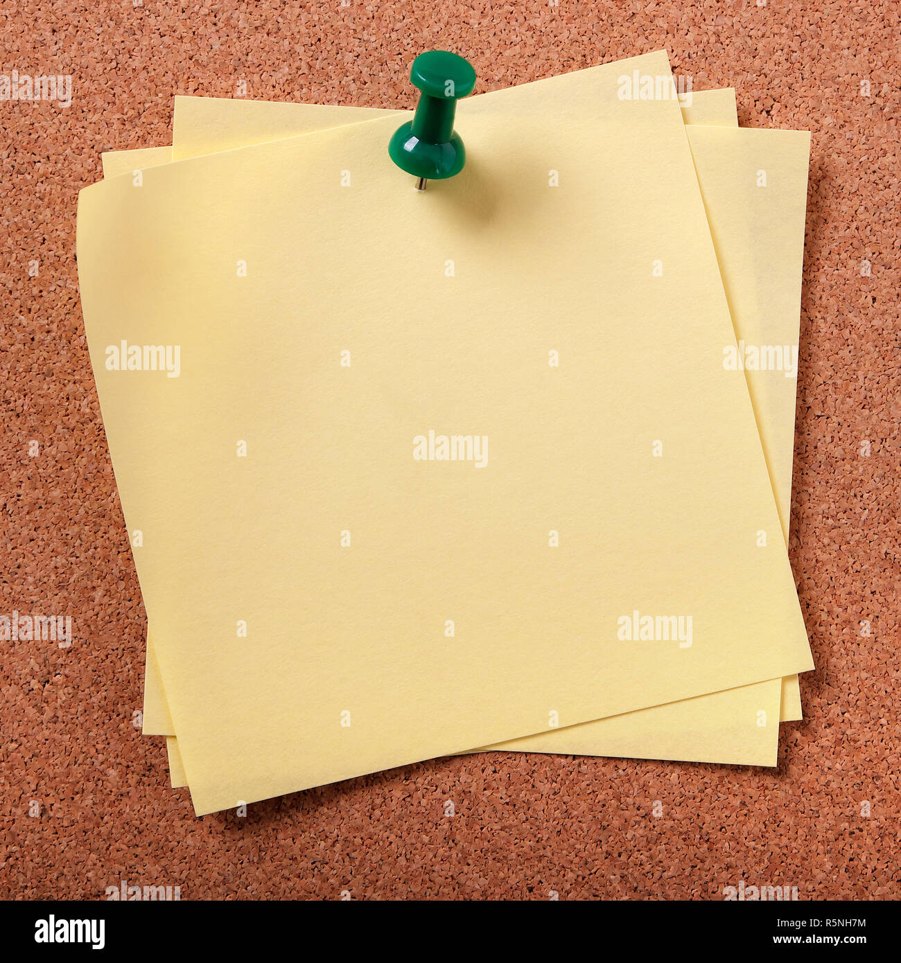 Several untidy sticky post notes pinned to cork board Stock Photo