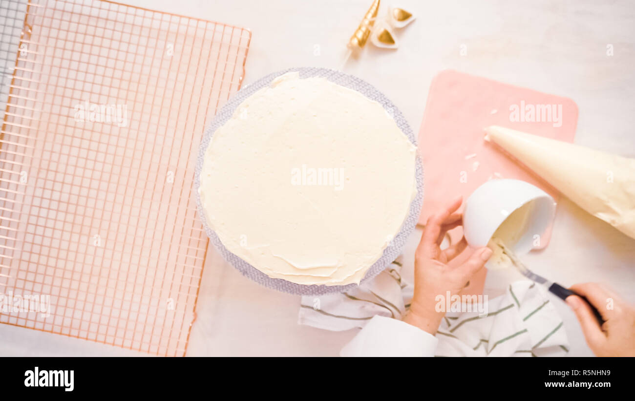 Flat lay. Frosting pink and purple cake with a white buttercream icing. Stock Photo