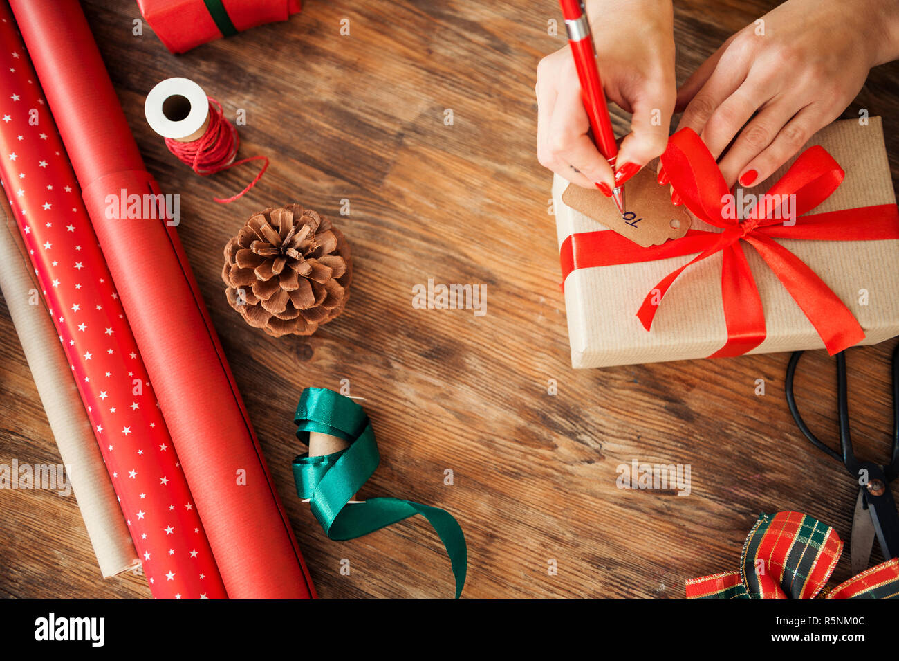 Woman Wrapping Christmas Gifts Overhead Shot Stock Photo