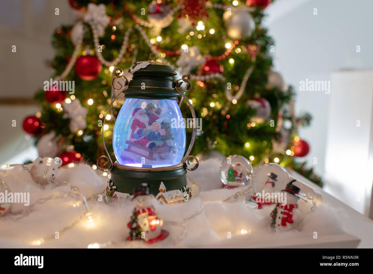 Christmas decoration, snow dome, globe with table decoration, Santaclaus on  sleigh with child in winter scene with snowflakes, reindeer snowglobe and  Stock Photo - Alamy
