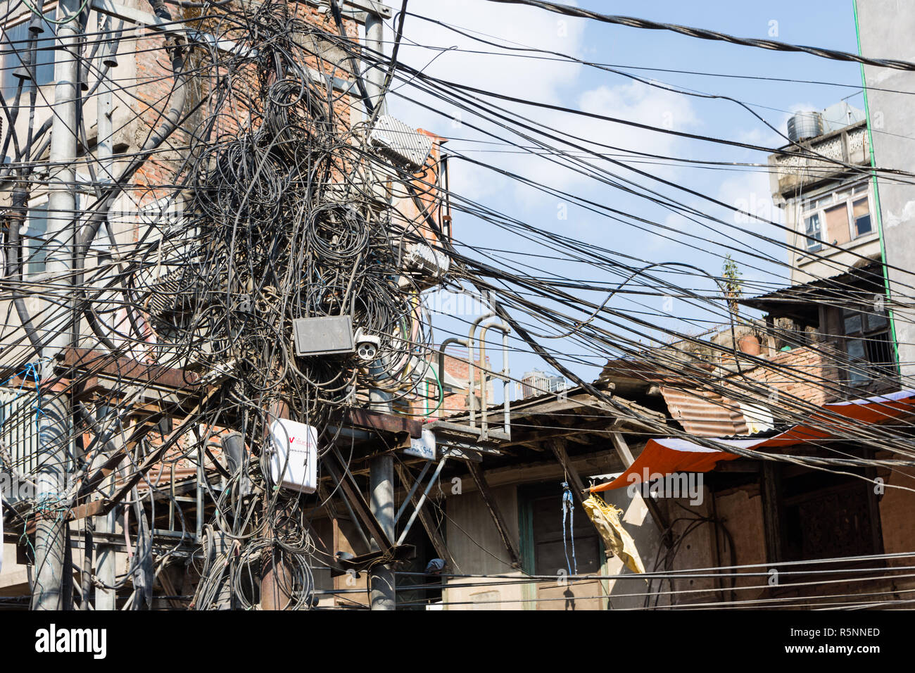 Utility pole with lots of entangled wires, Kathmandu, Nepal Stock Photo