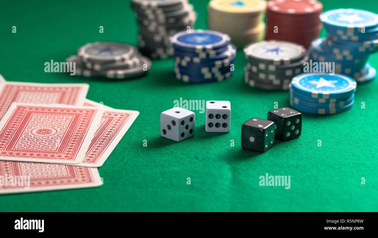 Casino, gambling concept. Poker chips piles, playing cards and dice on green felt background Stock Photo