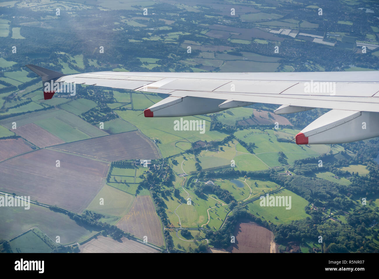 Window view of flying over the British countryside close to London, United Kingdom Stock Photo