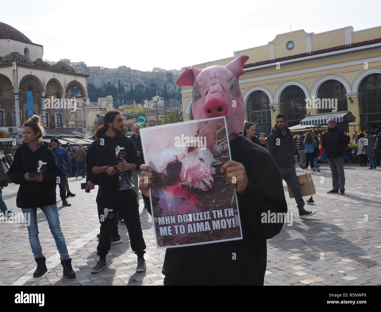 Athens, Greece. 01st Dec, 2018. A demonstrator wearing a pig mask holds ...
