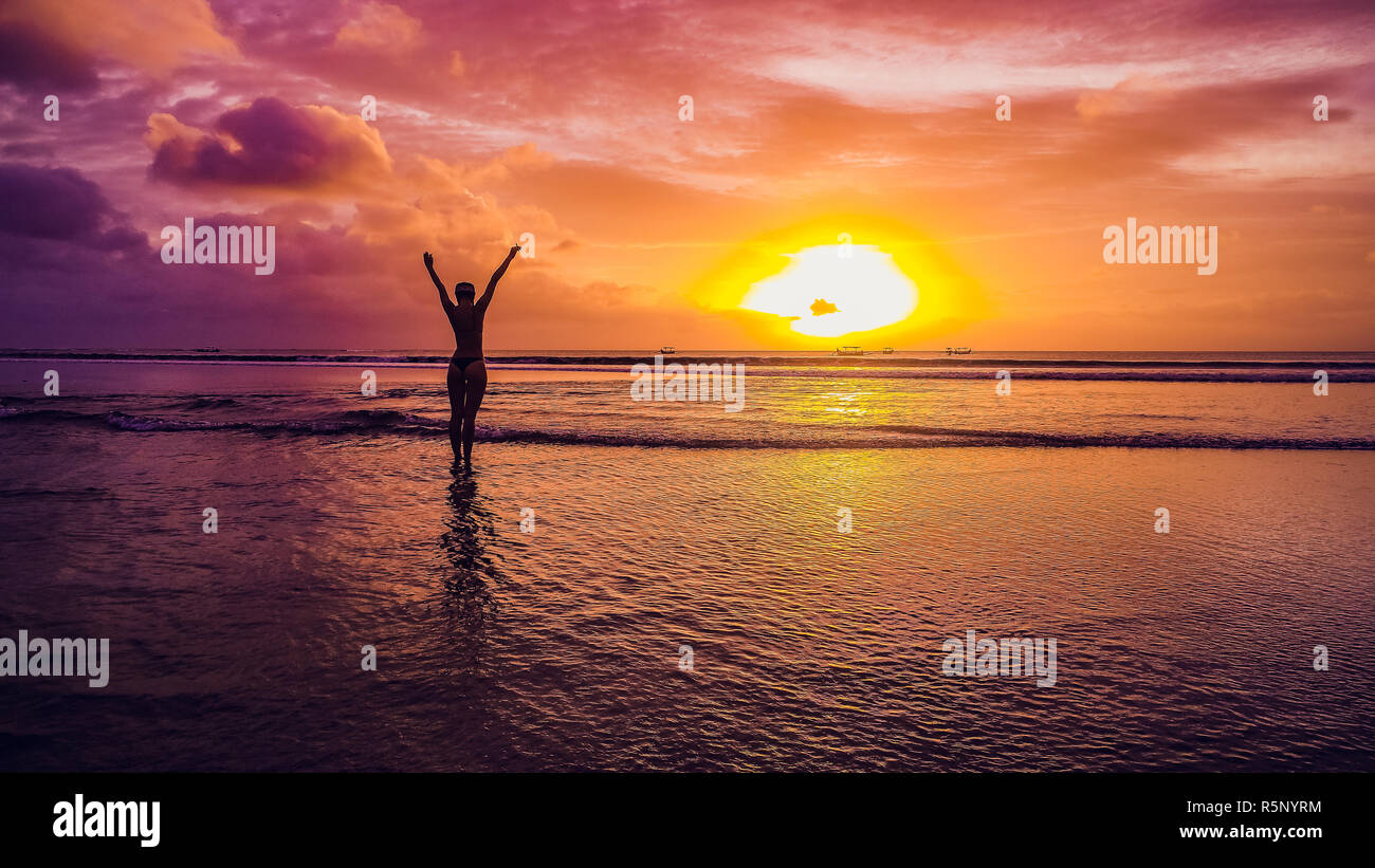 Beautiful Girl On A Sunset Background On A Sandy Beach Stock Photo