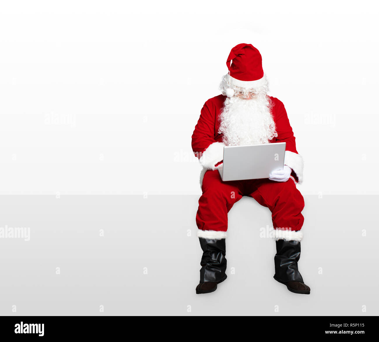 santa claus watching laptop and sitting on blank panel Stock Photo - Alamy